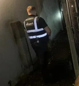 Airsec security officer carrying out a night patrol inspection